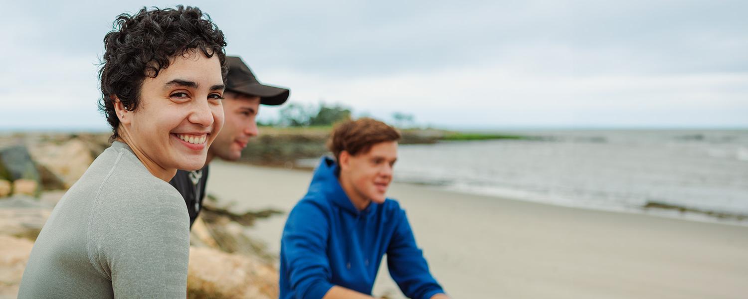 Smiling UB Students on the beach